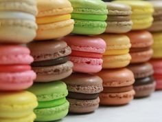 many different colored macaroons stacked on top of each other