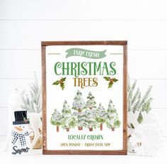 a christmas tree poster is displayed next to other holiday decorations