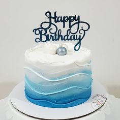 a birthday cake with blue and white frosting