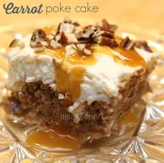 a close up of a piece of cake on a plate with caramel and pecans