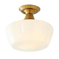 a light fixture with a white glass shade on the bottom and gold trimmings