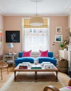 a living room filled with furniture and a fire place in front of a large window