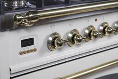 an oven with brass handles and knobs on it