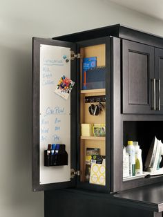 an open refrigerator with writing on the door and magnets attached to it's sides