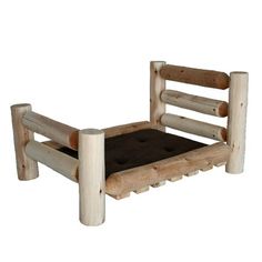 a wooden bed frame with a cushion on the bottom and sides, made out of logs