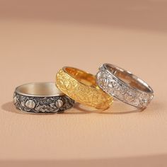 three different colored rings sitting on top of a table