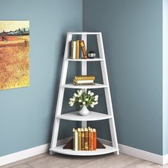 a tall white shelf with books on it in a room next to a blue wall