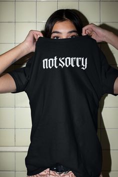 I ain't sorry. Goth style super soft tshirt will become your new staple for all your edgy outfits. Click through for this Not Sorry tshirt and more everyday goth looks at Lucida Mystica. Black T-shirt With Letter Print For Alternative Fashion, Slogan T-shirt For Alternative Fashion, Alternative Style Short Sleeve Shirt With Letter Print, Unisex Punk T-shirt With Letter Print, Black Edgy Shirt With Text Print, Edgy Black Shirt With Text Print, Edgy Crew Neck Shirt With Graphic Design, Alternative Slogan Tops For Streetwear, Black Edgy T-shirt With Back Print