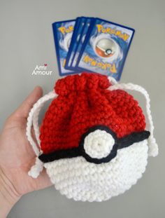 a hand holding a crocheted pokemon hat