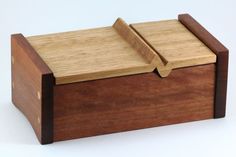 a wooden box with two pieces of wood in the lid and one piece missing from it