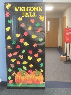 a door decorated with fall leaves and pumpkins in an office hallway that says welcome fall