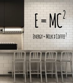 an energy = milk coffee sign is on the wall in this modern kitchen with bar stools