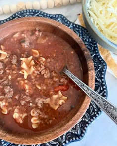 a bowl filled with pasta and meat soup