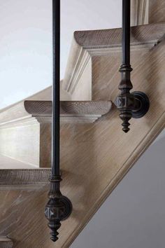 the stair railings are made from metal and wood