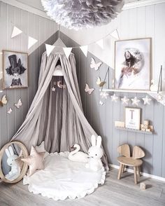 a baby's room decorated in white and grey