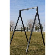 a metal frame sitting on top of a grass covered field