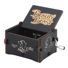 the beauty and the beast music box is black with gold lettering on it's lid