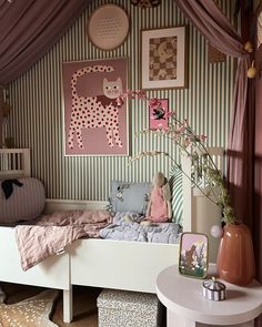 a child's bedroom decorated in pink and white