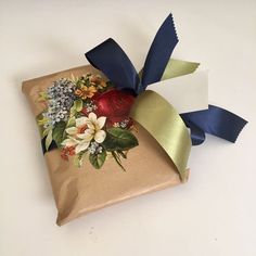 a present wrapped in brown paper and decorated with flowers