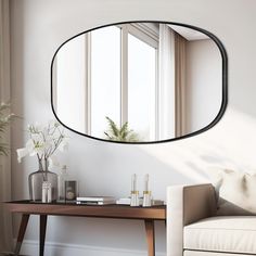 a living room with a couch, table and mirror