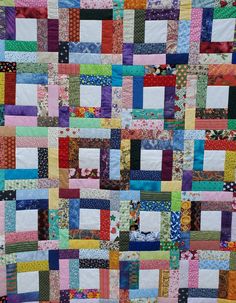 a multicolored patchwork quilt is displayed