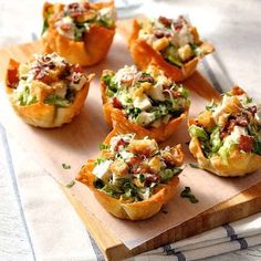 small appetizers are sitting on a cutting board