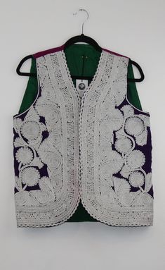 A rare find vintage sleeveless waistcoat from Afghanistan. Size: S/M Bust: 19 Inches Height: 23 Inches Note: Worn and minor signs of wear. Fitted Sleeveless Vest For Festive Occasions, Sleeveless Embroidered Cotton Nehru Jacket, Embroidered Sleeveless Nehru Jacket For Spring, White Sleeveless Nehru Jacket For Spring, Spring Sleeveless Fitted Nehru Jacket, Traditional Summer Vest, Traditional Fitted White Vest, Traditional Sleeveless Summer Vest, Fitted Traditional White Vest