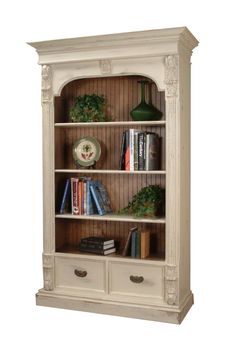 a white bookcase with two drawers and some books