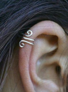 a woman's ear is shown with the word love written in silver on it