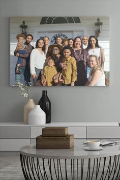 a family photo hanging on the wall above a coffee table