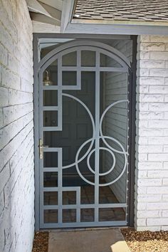 an iron gate is open on the outside of a home's front door,