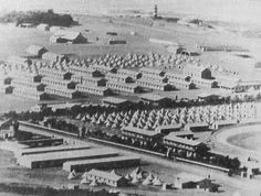 an old black and white photo of many buildings