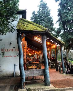 an outdoor restaurant with lights on the roof