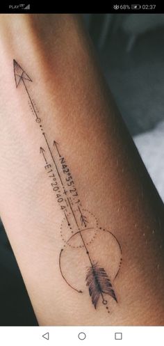 a tattoo with an arrow on the arm