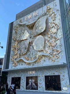 the exterior of dior's new store in hong kong, where it has been decorated with gold and white flowers