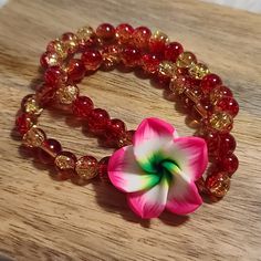 Handmade Stretch Bracelet. Hawaiian Flower With Double Beaded Bracelet Attached. Can Fit Wrists From 5 To 8 Inches Round Nicely. Save More $$$ On Bundles!!! Buy 3 Or More Items And Receive 30% Off!!! I Ship On The Same Day Unless You Make A Purchase At Night Then I Ship First Thing The The Morning. I Am A Quick Responder And If You Have Any Questions About An Item I Will Quickly Give You An Answer Or Post A Video Of The Item In Question. I Try To List All My Items At A Reasonable Price But I Als Adjustable Flower Beaded Bracelet With 8mm Beads, Flower Shaped Stretch Bracelet For Gift, Flower Shaped Stretch Bracelet As Gift, Flower-shaped Stretch Bracelet As Gift, Handmade Spiritual Flower Beaded Bracelets, Red Flower-shaped Beads For Gifts, Bohemian Red Flower Bracelets, Adjustable Red Flower Beaded Bracelet, Red Flower Shaped Bracelets For Gifts