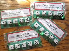 four white dices sitting on top of a wooden table next to green stringing