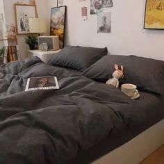 a bed that has some pillows on it and a stuffed animal in front of it