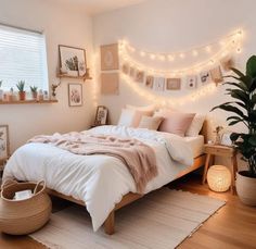 a bedroom with lights strung above the bed and rugs on the wooden flooring