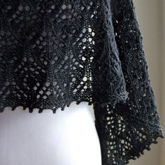 a black crocheted shawl on a mannequin