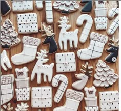 christmas cookies decorated with white and black icing are on a table next to each other