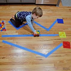 a young boy playing with blocks on the floor