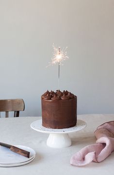 a chocolate cake with a sparkler on top