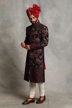 Blue silk velvet sherwani with floral, bird embroidered motifs and mandarin collar. Paired with kurta, pyjama and pair of juttis.
Component: 3 and Pair of Juttis
Pattern: Embroidered
Type Of Work: Bird, Floral
Neckline: Mandarin
Sleeve Type: Full Sleeves
Fabric: Silk Velvet, Cotton Silk
Color: Blue
Other Details: 
Floral and bird embroidery
Note: Safa and kalangi worn by the model is not for sale
Note: Please get in touch with customer care for preferred size of juttis 
Occasion: Wedding,Groom - Traditional Velvet Sherwani For Wedding, Festive Velvet Sherwani For Wedding, Traditional Velvet Sherwani For Festive Season, Traditional Velvet Sherwani With Zari Work, Traditional Formal Velvet Traditional Wear, Traditional Velvet Formal Wear, Formal Velvet Traditional Wear, Festive Embroidered Velvet Sherwani, Velvet Traditional Ceremonial Wear For Eid