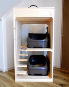 two plastic containers are sitting on top of each other in a storage area under the stairs