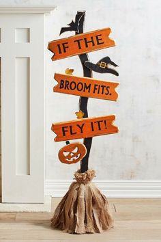 a wooden sign that says if the broom fits fly it with pumpkins and jack - o'- lanterns