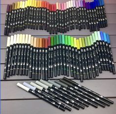 many different colored pens lined up next to each other