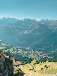 a scenic view of mountains and valleys from the top of a hill