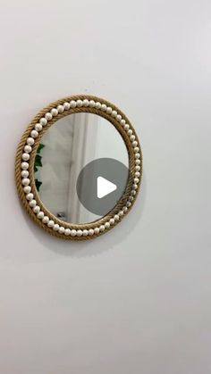 a round mirror hanging on the wall