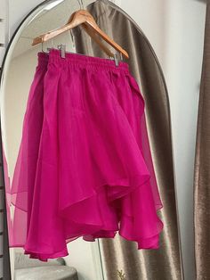 A flowing flared silk skirt cut out of layers of organza, the Freesia Skirt is an image of grace and romance. Wear with your favorite tee or the matching Lin Organza Tee. Elastic silk waistband, delicately lined with silk habotai for coverage. Available in fuchsia. 100% silk organza, silk habotai. Made in New York's Garment District by a small team of dedicated seamstresses. Ships in 10 business days. Flowy Pleated Party Skirt, Flowy Draped Skirt With Ruffles For Party, Party Tiered Draped Skirt With Gathered Details, Silk Flowy Tiered Skirt Dress, Flowy Tiered Silk Dress, Flowy Silk Tiered Skirt Dresses, Silk Skirted Bottoms For Party, Silk Dresses With Flowy Tiered Skirt, Elegant Flowy Silk Chiffon Skirt